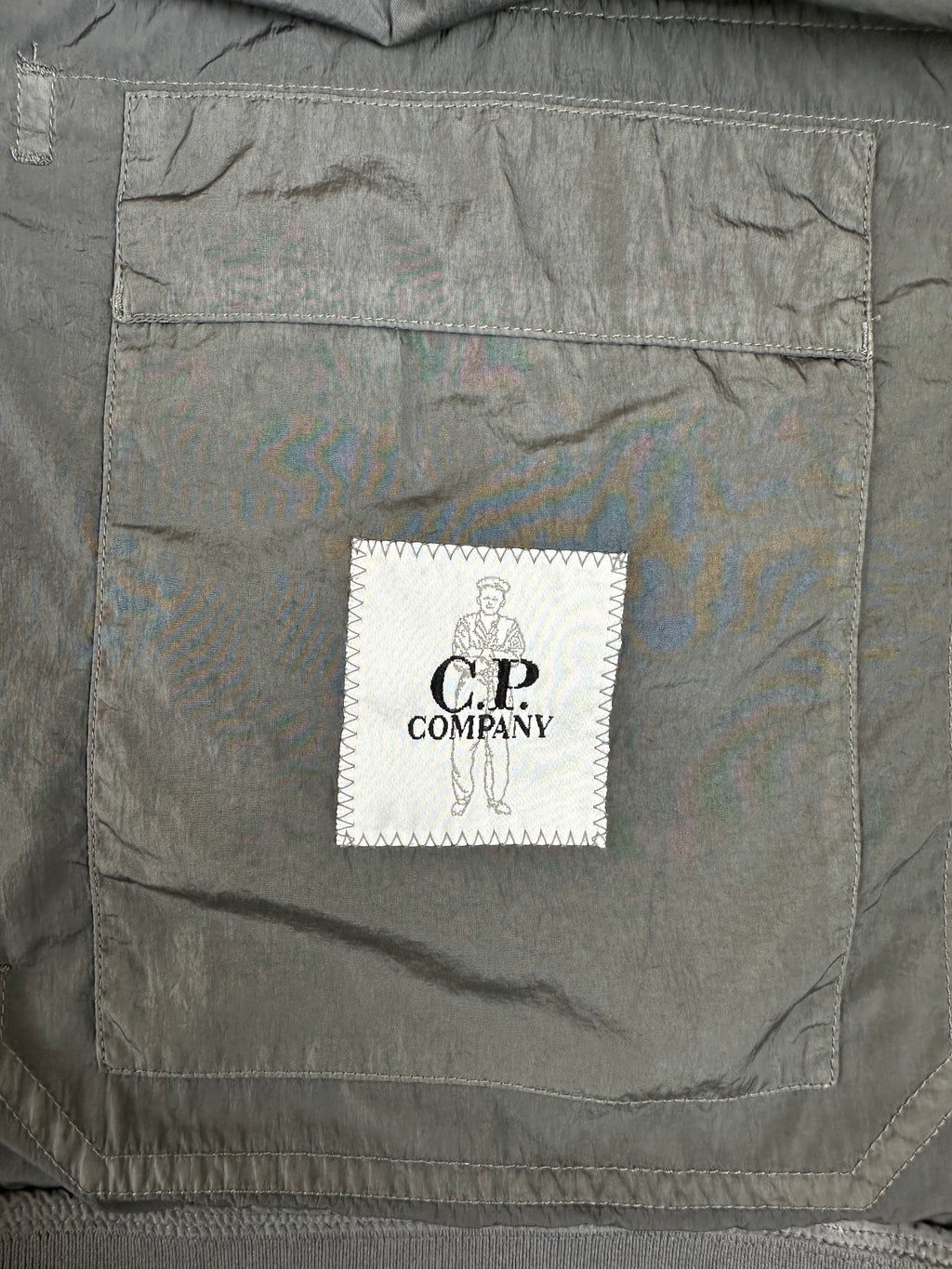 Gray fabric with a brand label on a gray background