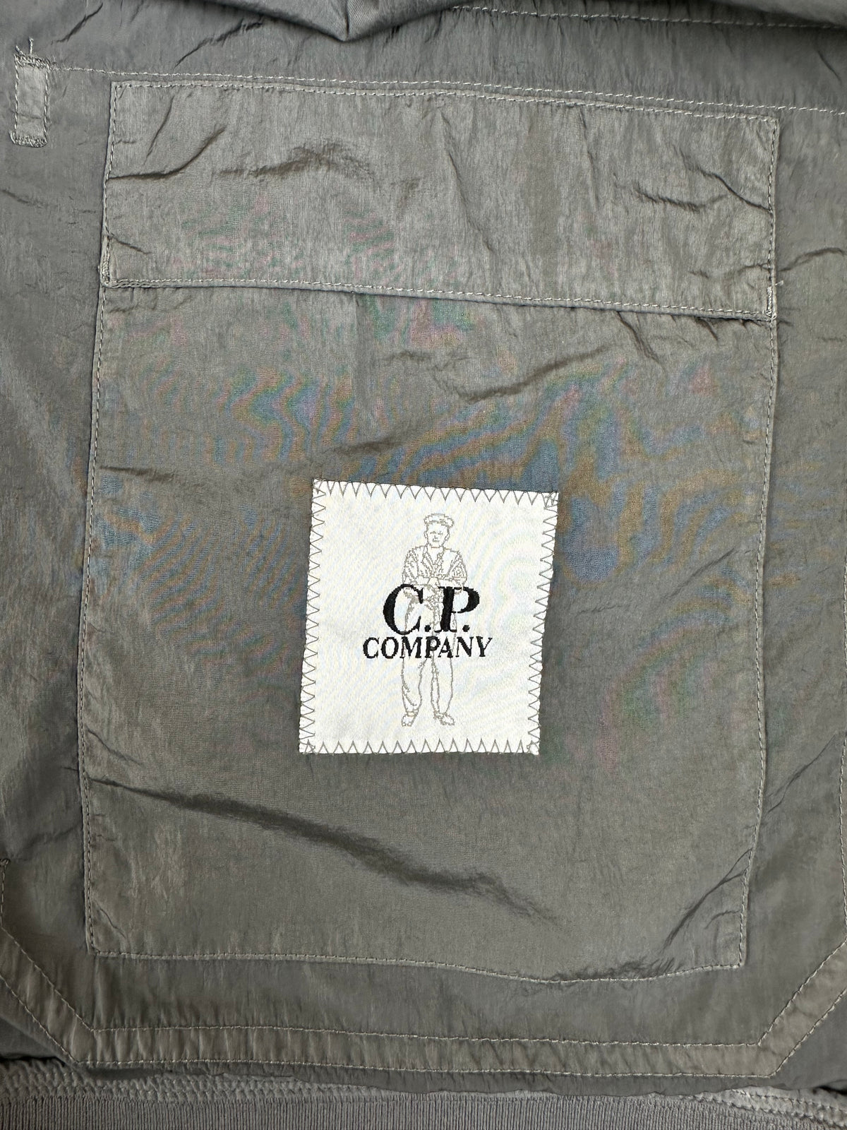 Gray fabric with a brand label on a gray background