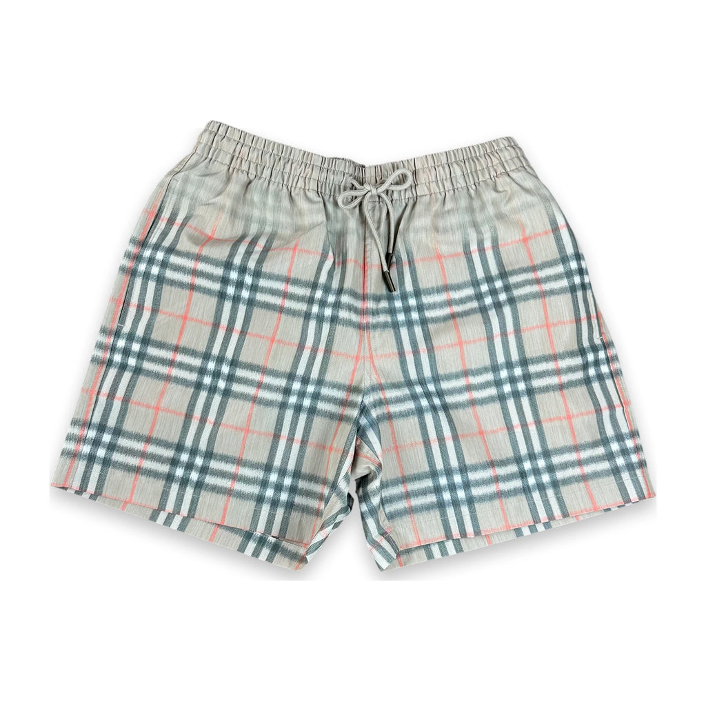 A pair of plaid shorts in a light gray-beige fabric with a classic tartan pattern in teal green and coral pink, featuring an elastic waistband and drawstring.