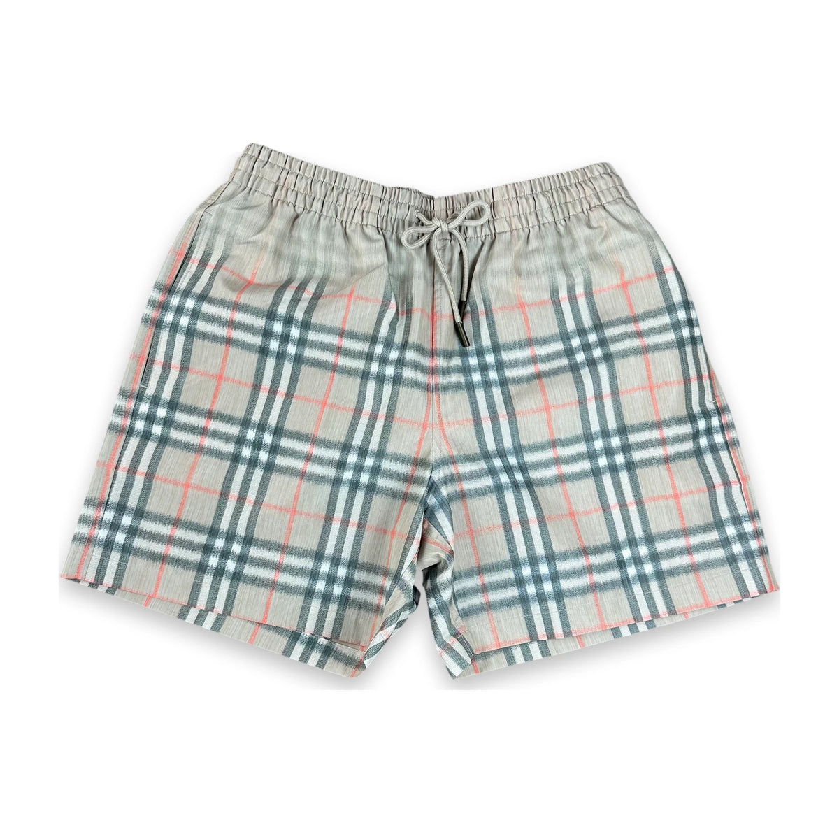 A pair of plaid shorts in a light gray-beige fabric with a classic tartan pattern in teal green and coral pink, featuring an elastic waistband and drawstring.