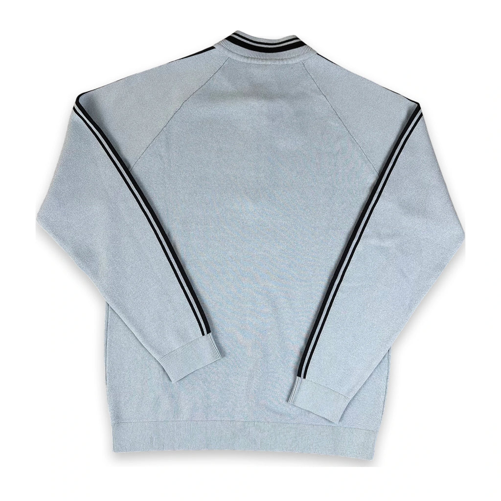 A light gray heathered long-sleeve track jacket shown from the back, featuring black and white double stripes running down the sleeves and around the ribbed collar.