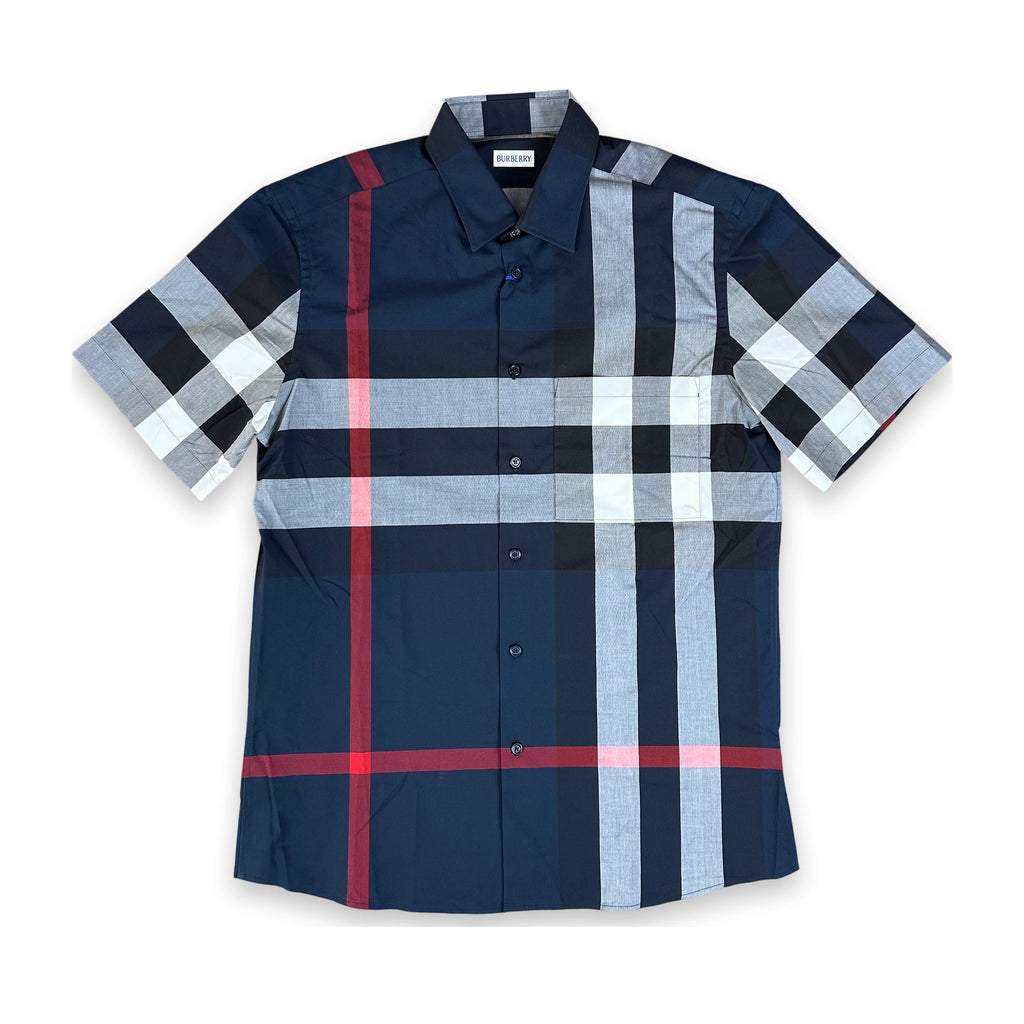 A short-sleeve button-up plaid shirt in navy blue, light gray, white, and red, laid flat against a white background.