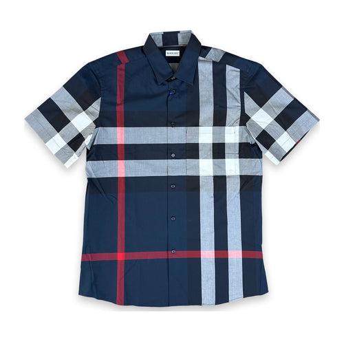 A short-sleeve button-up plaid shirt in navy blue, light gray, white, and red, laid flat against a white background.