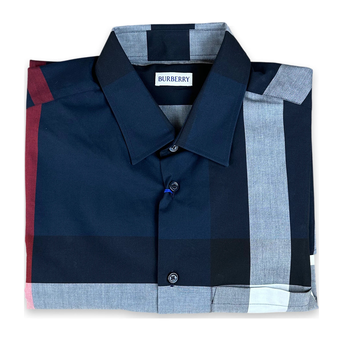 A folded Burberry check shirt in navy, light gray, and red, displayed on a clean white background.