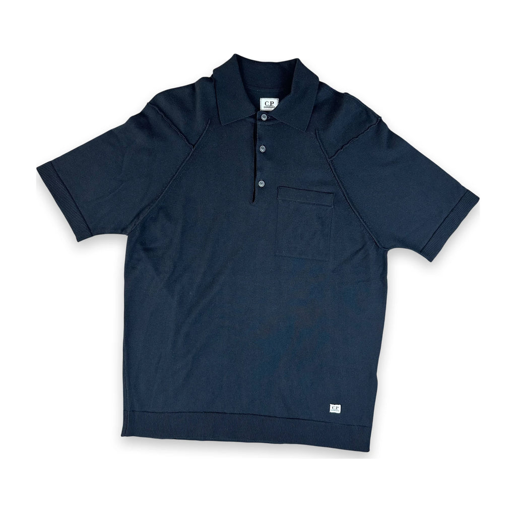 A dark navy blue short-sleeve polo shirt with a two-button placket and a chest pocket, laid flat against a white background.