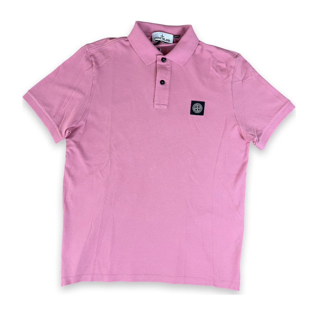 A pink short-sleeve polo shirt with a two-button placket and a small black square logo patch on the left chest, displayed flat against a white background.