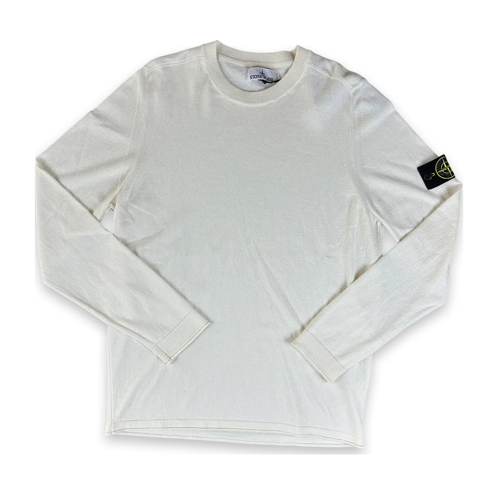 An off-white long-sleeve crewneck shirt by Stone Island, featuring the brand's signature compass badge on the left sleeve, laid flat against a white background.