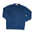 A navy blue long-sleeve crewneck shirt with the Stone Island compass patch on the left sleeve, laid flat on a white background.