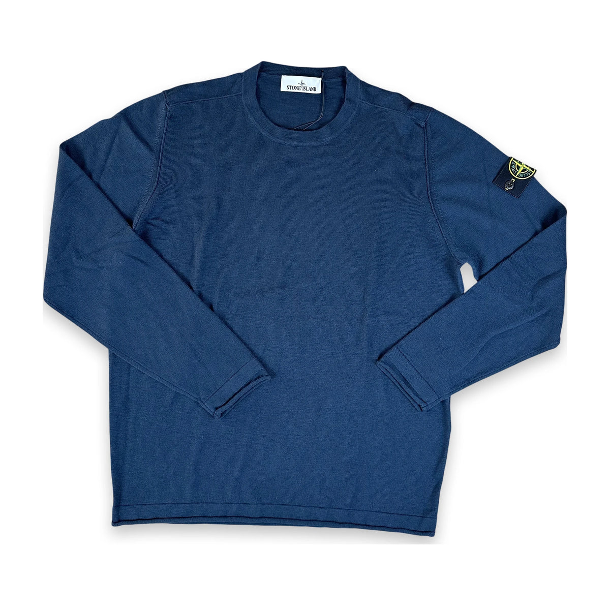 A navy blue long-sleeve crewneck shirt with the Stone Island compass patch on the left sleeve, laid flat on a white background.