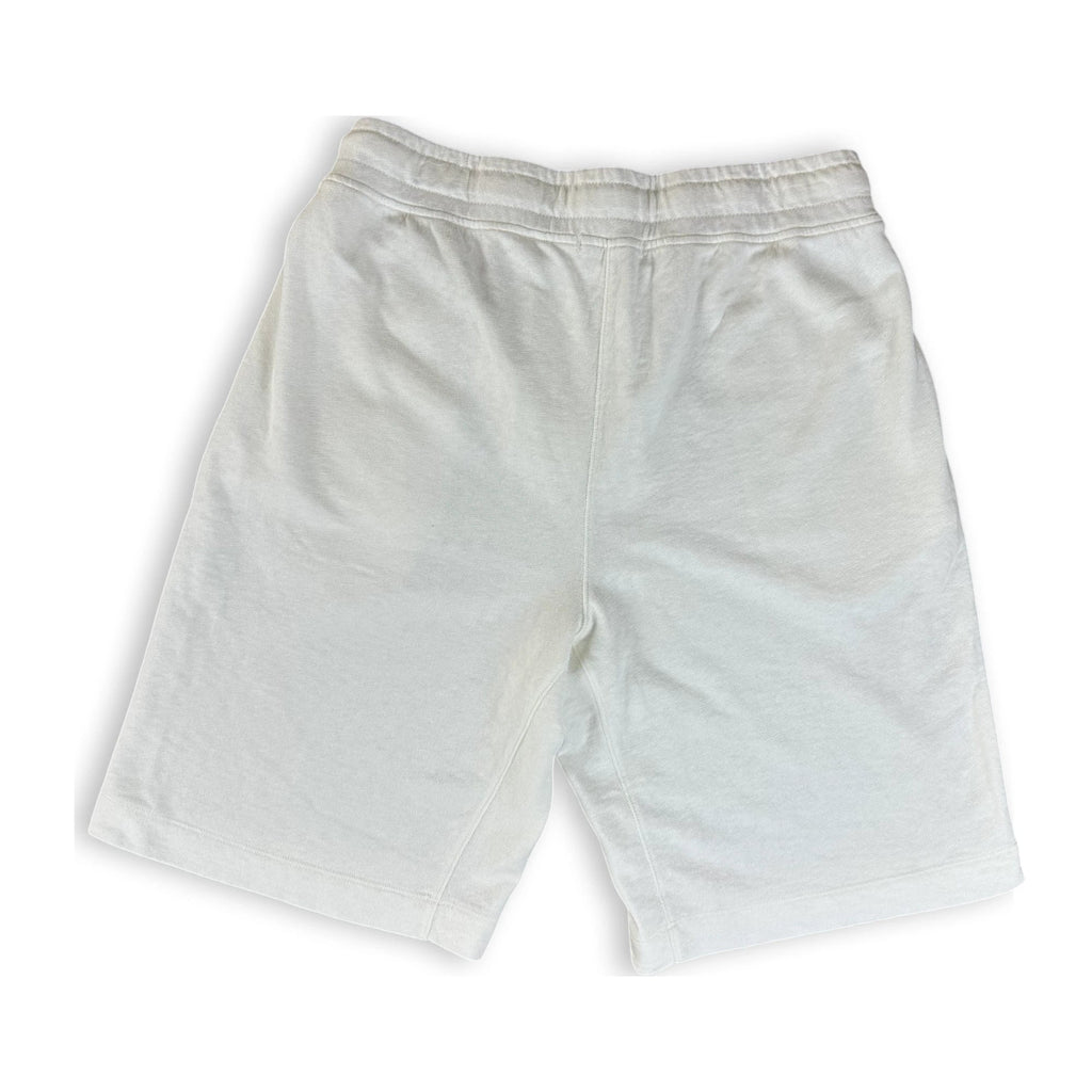 A pair of white cotton shorts with an elastic waistband, laid flat on a white background.
