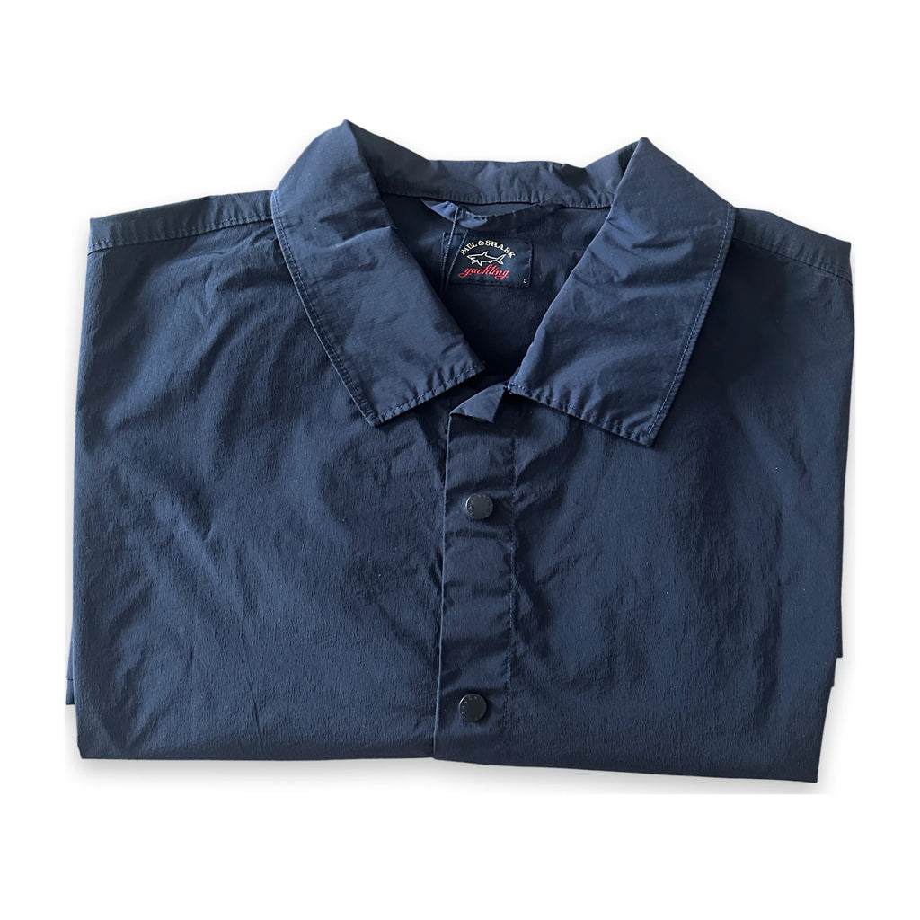 A folded navy blue long-sleeve button-up shirt with a pointed collar, laid flat on a white background.