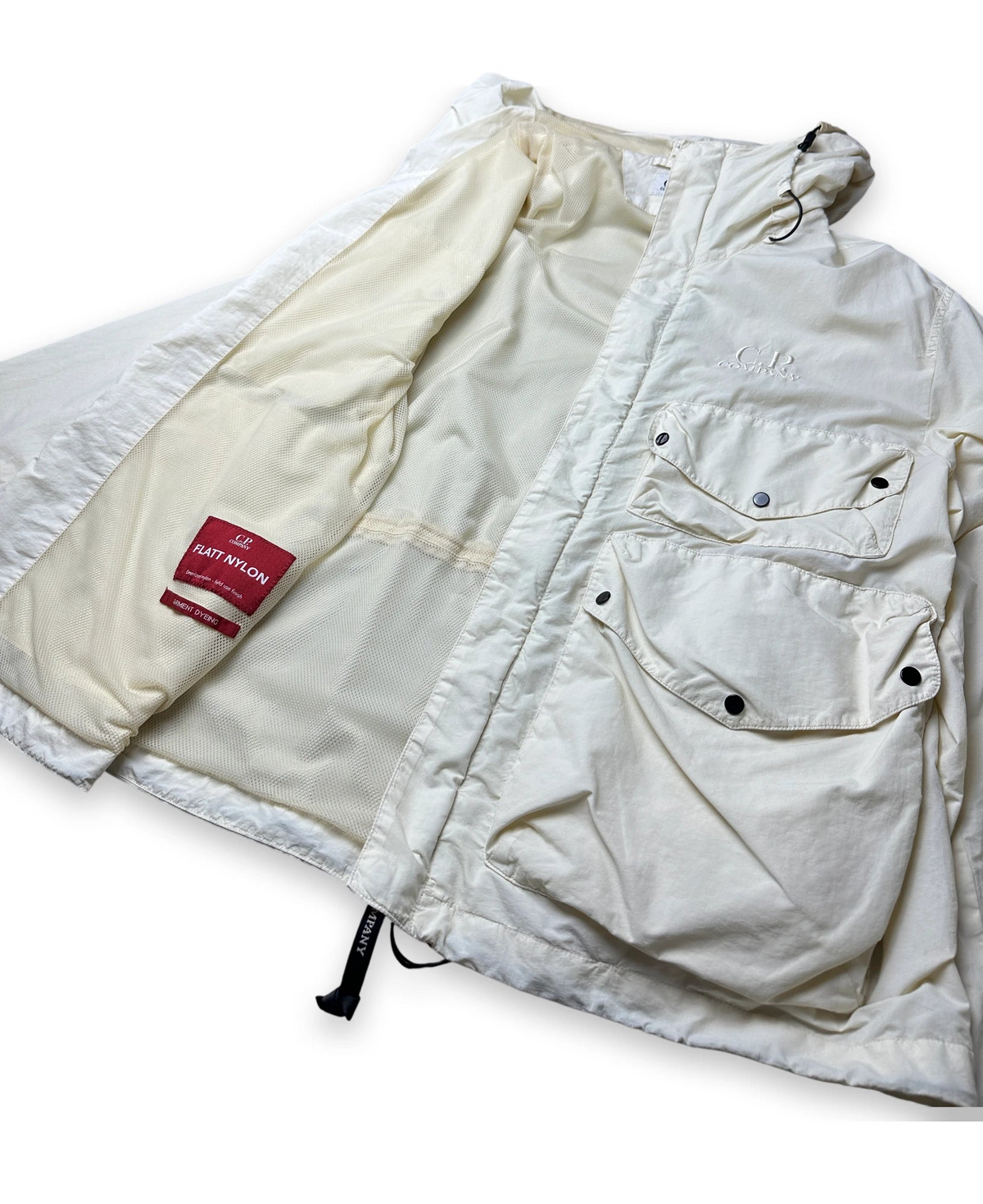 A cream-colored puffer jacket with a quilted design, multiple utility pockets, and a red 'FLATT NYLON' brand label on the inner lining, shown against a plain white background.