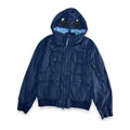 A navy blue hooded jacket with a unique integrated hood design featuring two circular black visor-like elements on the hood, photographed against a solid white background.