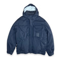A navy blue hooded utility jacket with multiple front pockets and a small white embroidered logo patch on the left chest, displayed against a plain white background.