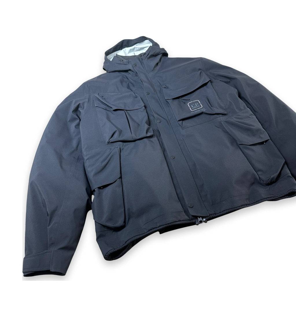 Navy jacket with C.P. Company logo on a white background