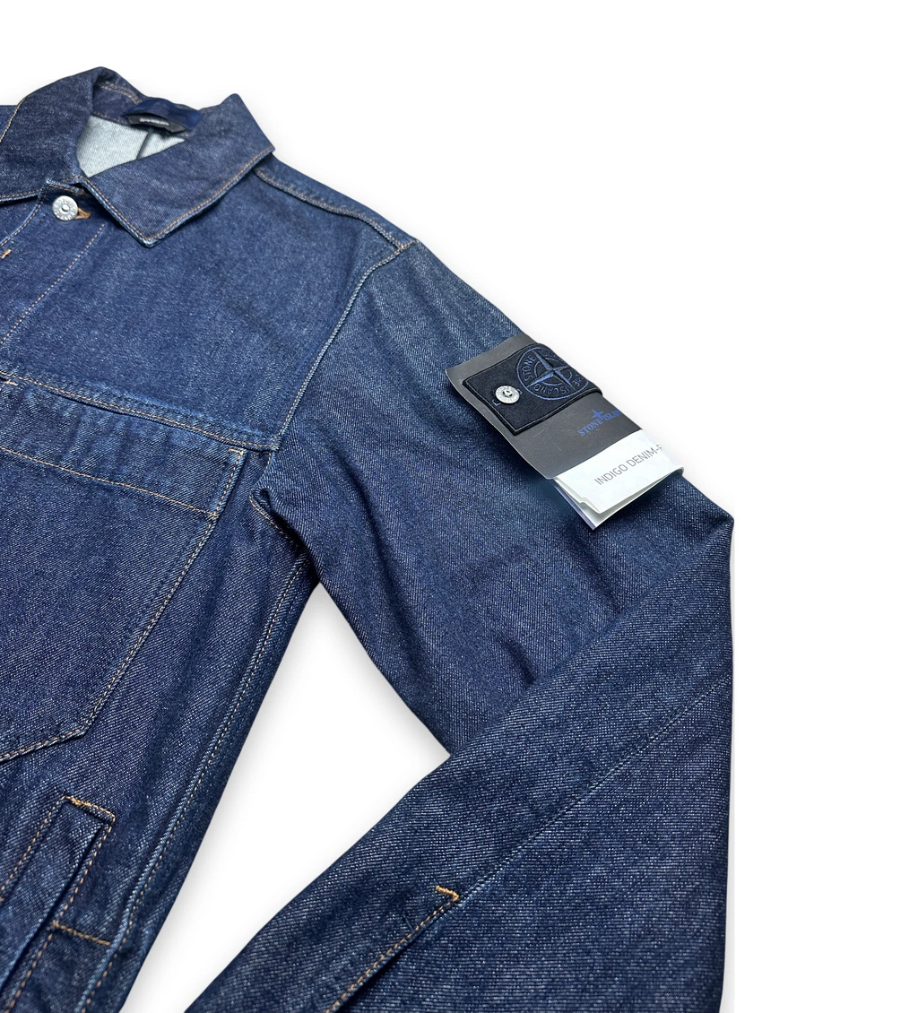 Sleeve of a denim jacket with compass badge of Stone Island