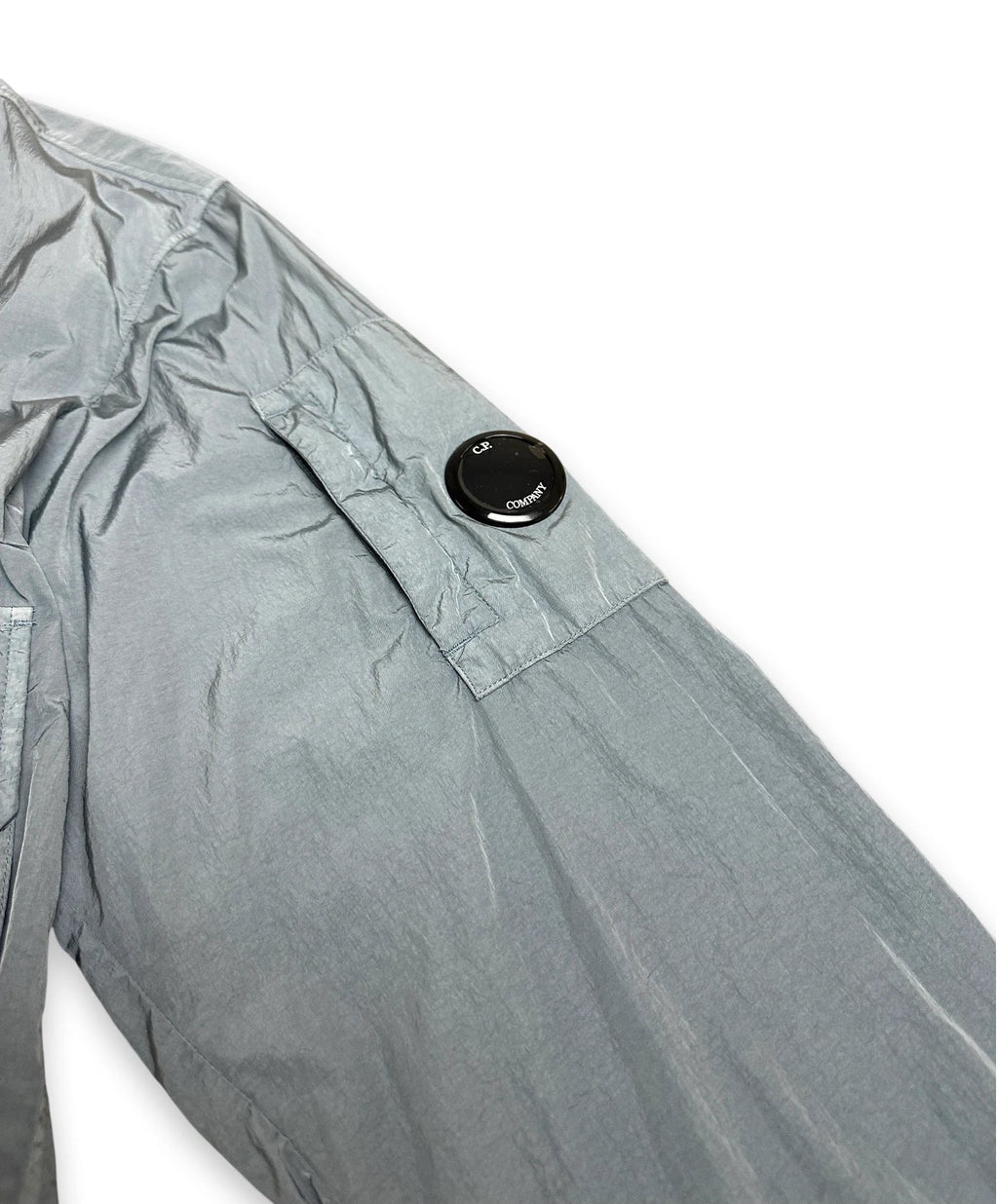 Chrome sleeve of bomber jacket with iconic C.P. Company lens on sleeve