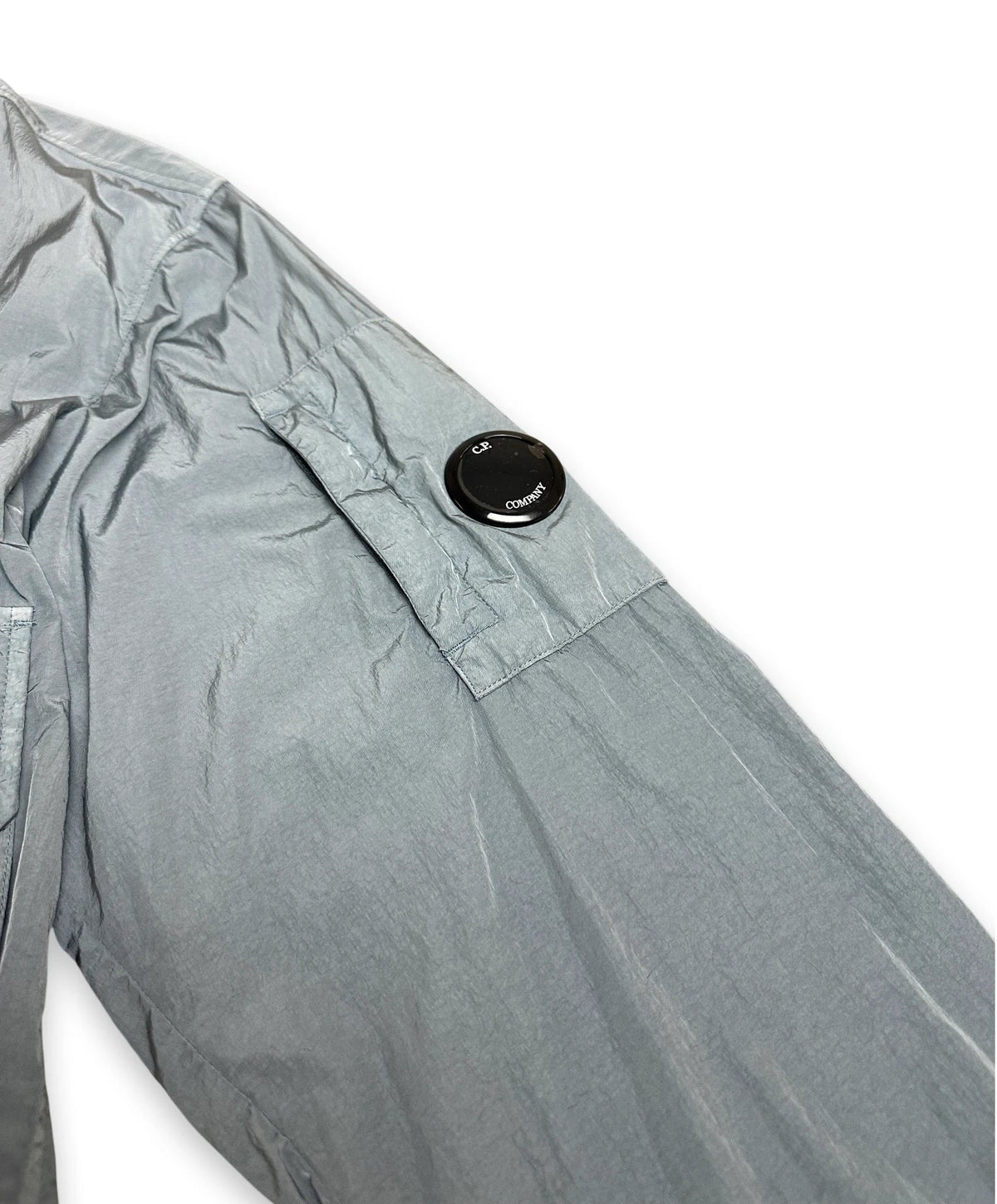 Chrome sleeve of bomber jacket with iconic C.P. Company lens on sleeve