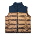 A color-blocked puffer vest with a navy blue upper section and a metallic bronze quilted lower section, featuring a full front zipper and a small brand patch near the bottom right.