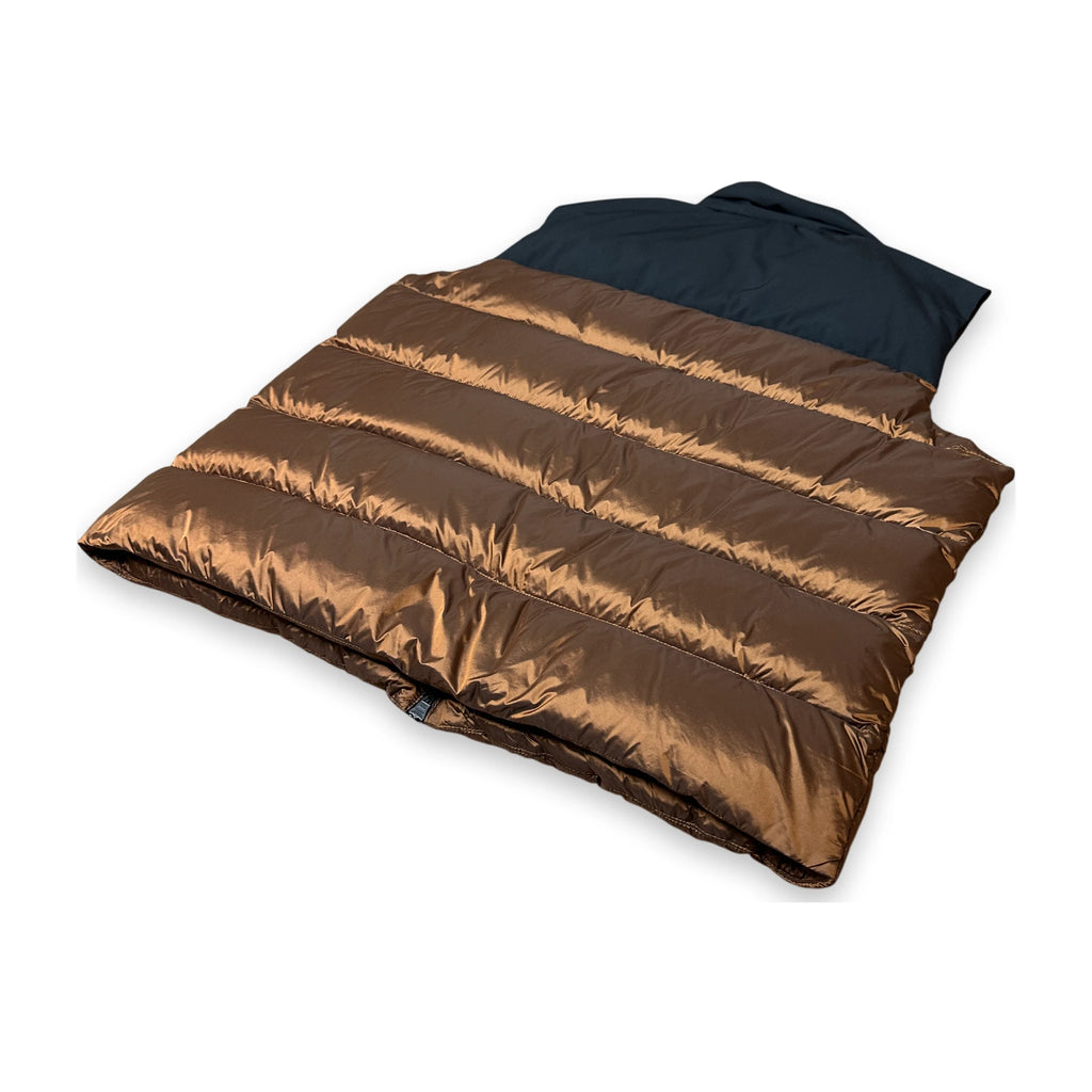 A puffer sleeping bag or duvet with horizontal quilting in a metallic bronze-brown, featuring a dark navy blue hood or neck insert, shown on a clean white background.