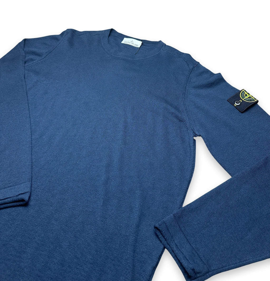 A navy blue long-sleeve crewneck shirt with the Stone Island compass patch on the left sleeve, displayed flat against a white background.