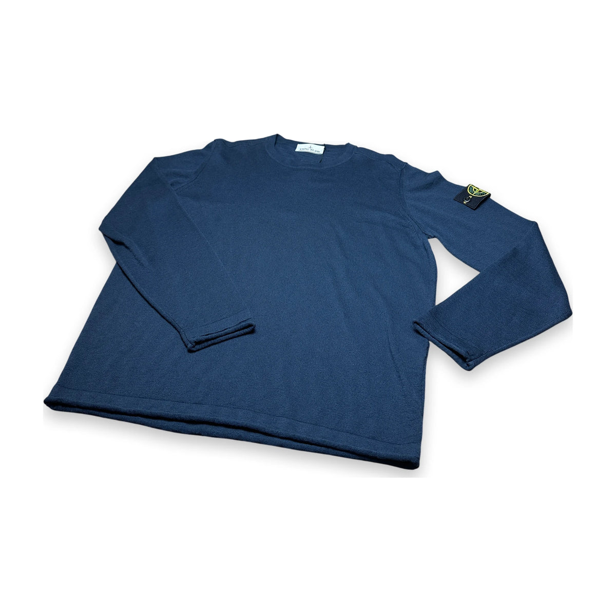 A navy blue long-sleeve crewneck shirt with the Stone Island compass logo patch on the left sleeve, displayed on a clean white background.