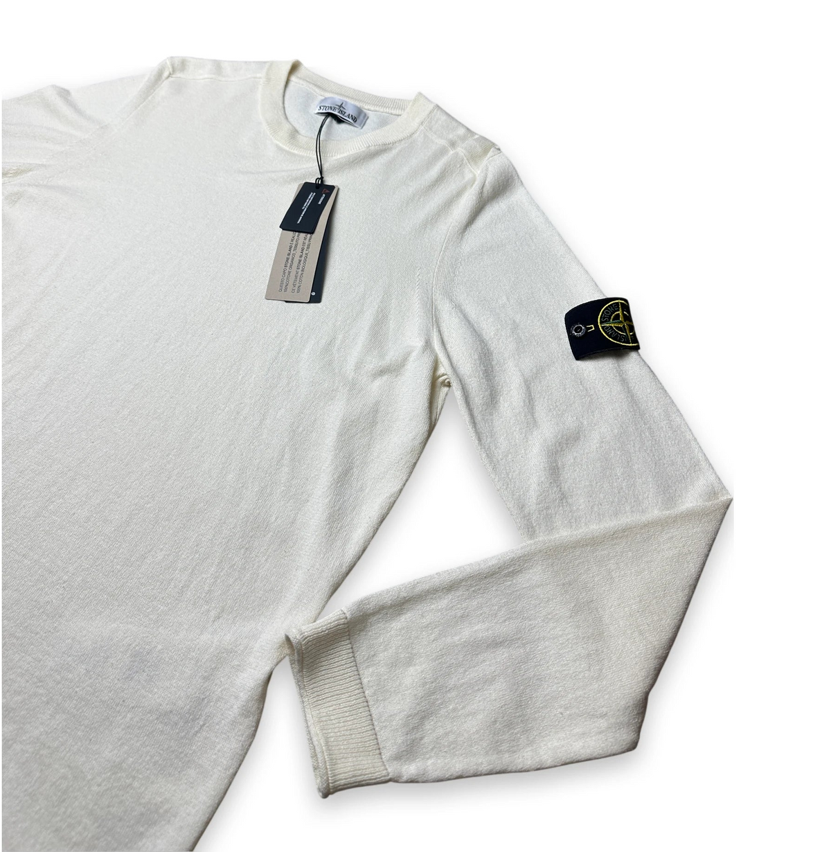 Off white jumper with compass badge on the sleeve of Stone Island