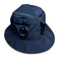 Navy bucket hat with C.P. Company lens on a white background
