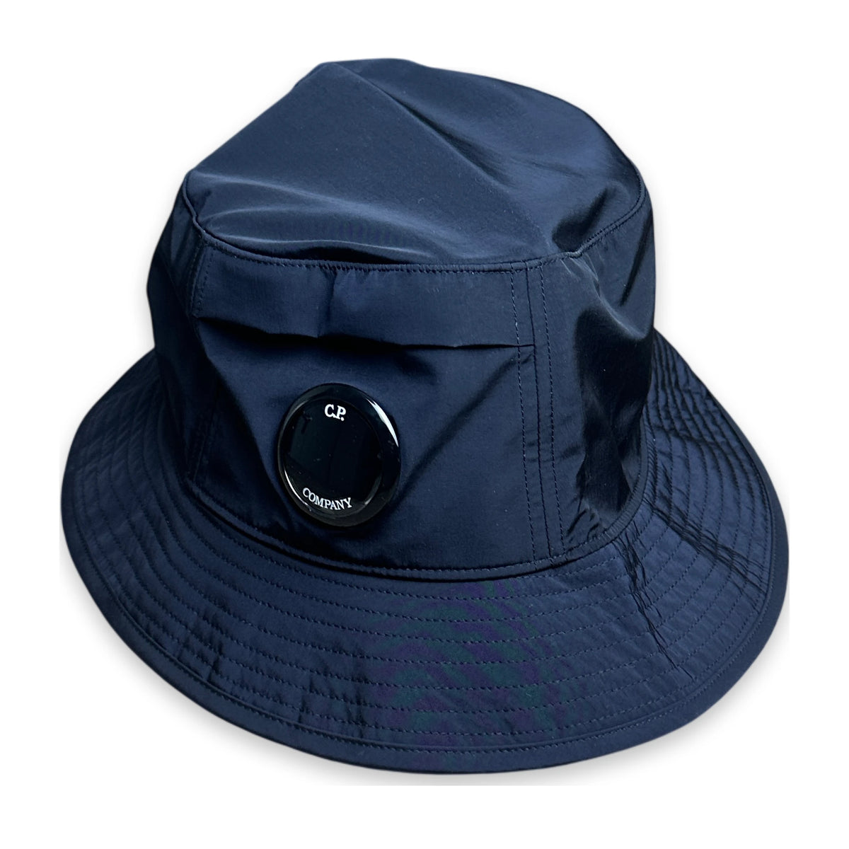 Navy bucket hat with C.P. Company lens on a white background