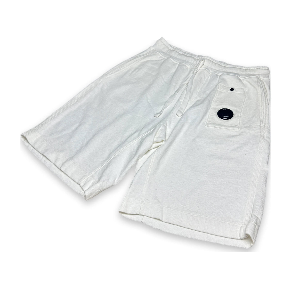 White relaxed sweatpants with a lens of C.P. Company on a white background