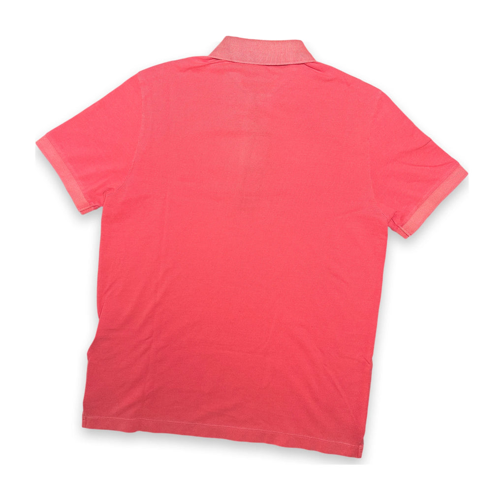 A coral pink short-sleeve polo shirt shown from the back, laid flat against a white background.