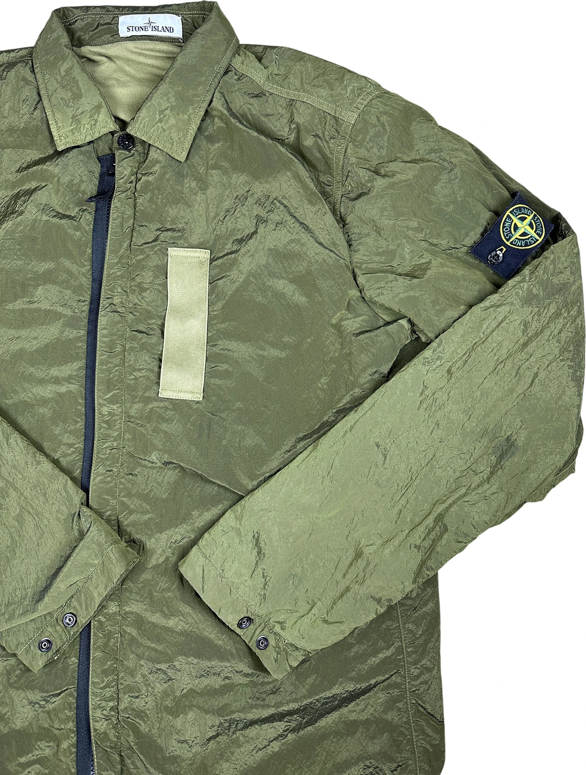 Nylon Metal jacket in green with iconic stone island badge flat layed on a white background